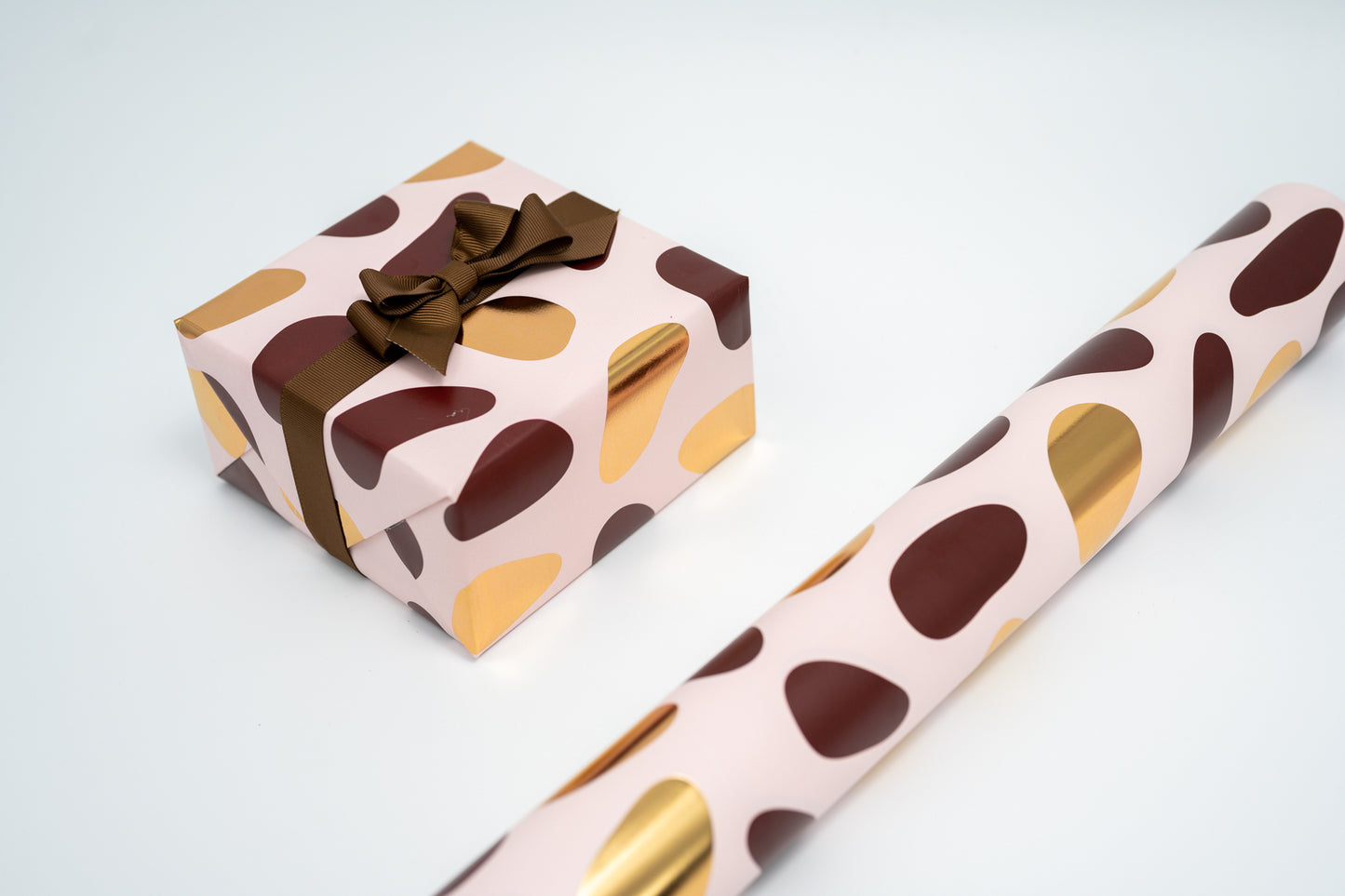 PEBBLES GIFT WRAPPING PAPER IN PINK, BROWN AND GOLD