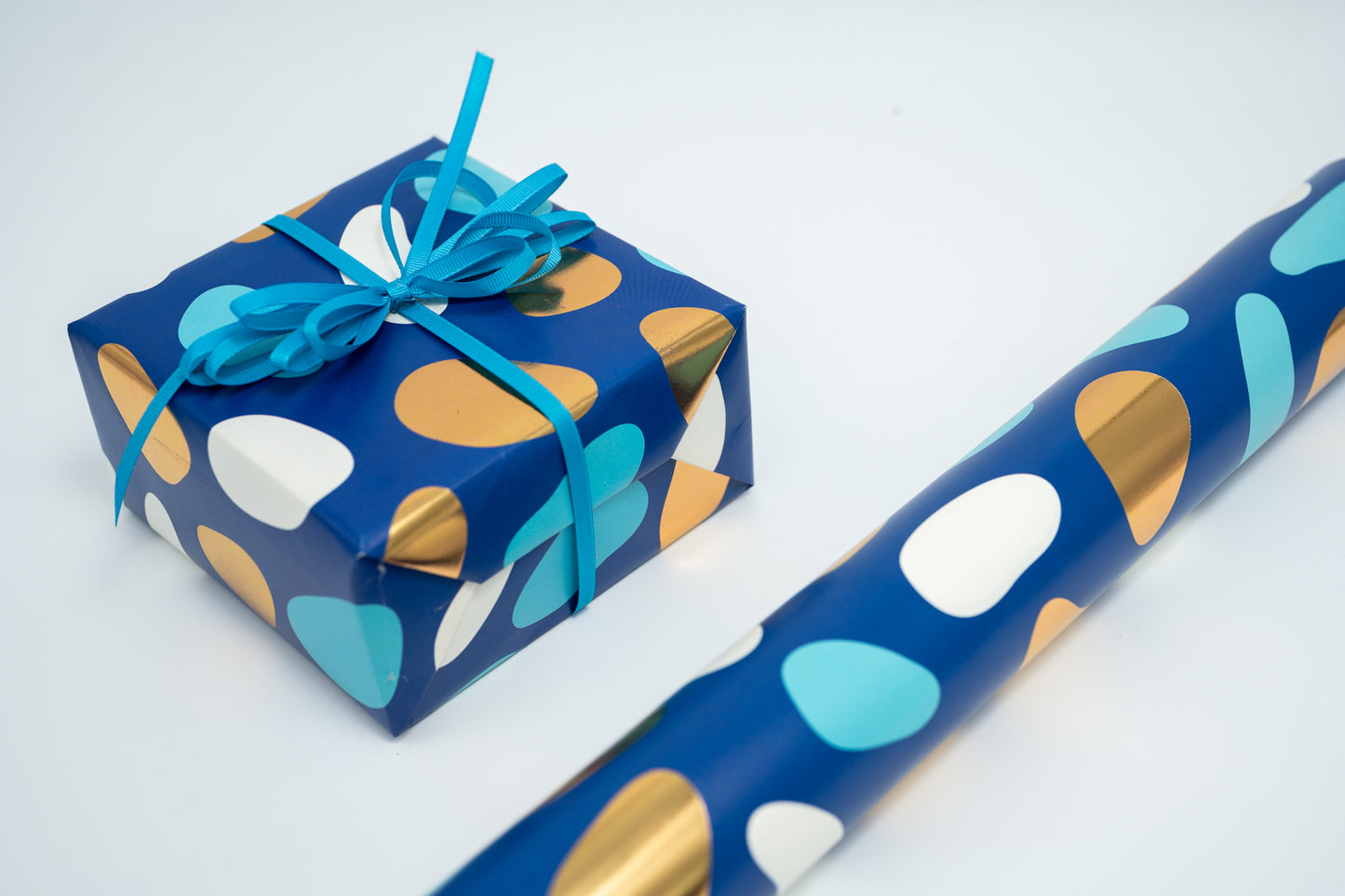 PEBBLES PRINT WRAPPING PAPER IN TURQUOISE AND GOLD