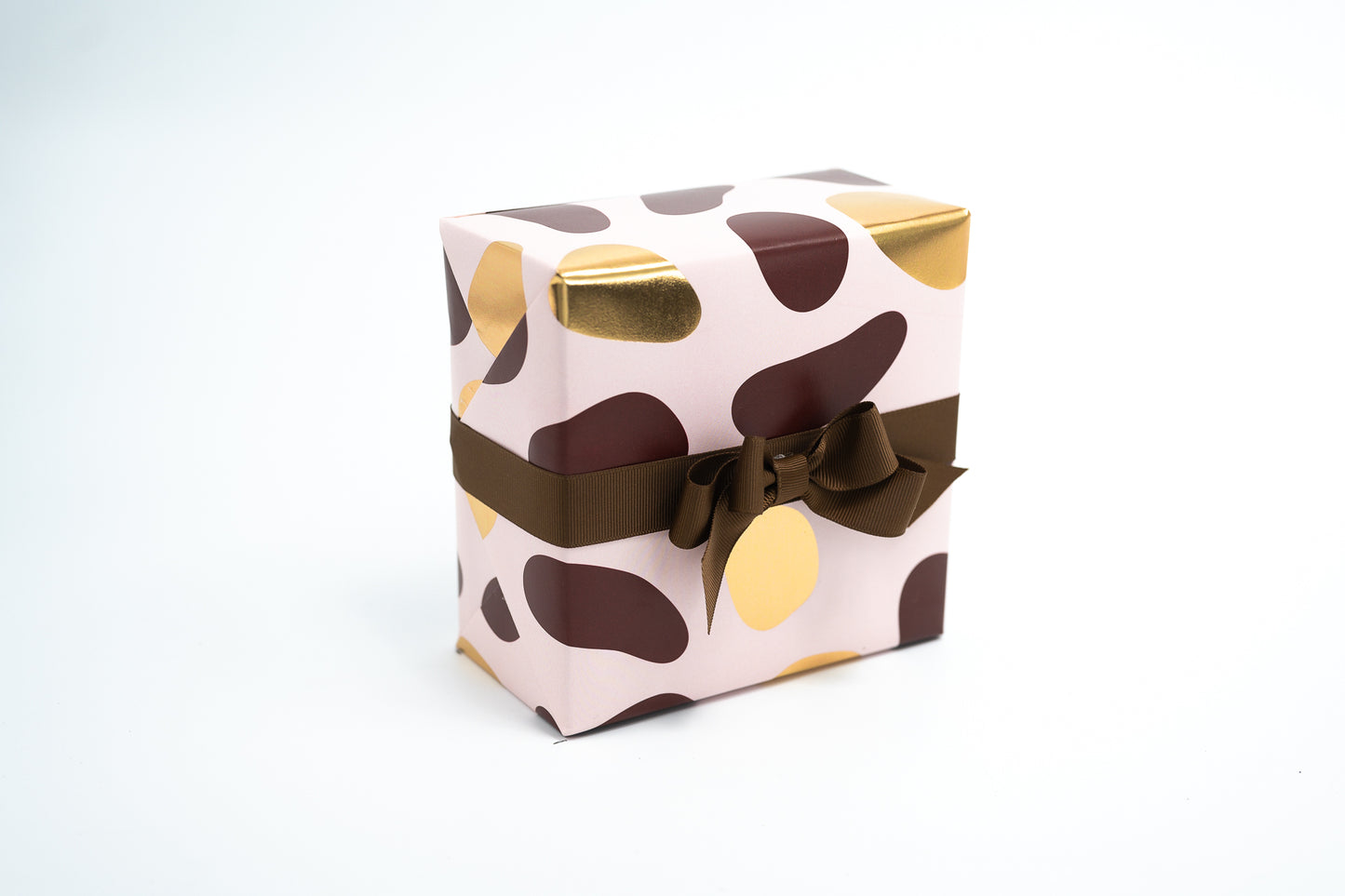 PEBBLES GIFT WRAPPING PAPER IN PINK, BROWN AND GOLD